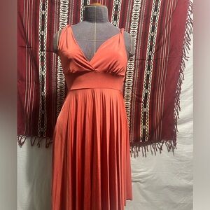 Salmón colored sleeveless petite dress with pleated flair bottom half